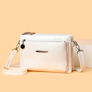 Minimalist off-white multi-layer faux leather crossbody bag with metallic detail