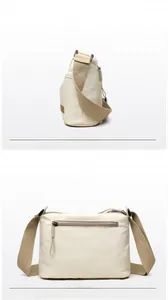 Front and back views of beige nylon crossbody bag with adjustable strap and zip pocket
