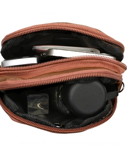 Top view of brown leather crossbody bag with double zippers showing spacious interior