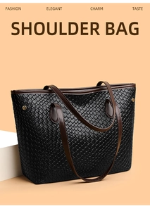 Detail of black woven texture shoulder bag with dark brown leather straps and gold rivets