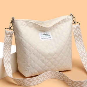 Beige quilted rhombic shoulder bag with a patterned wide strap and letter patch