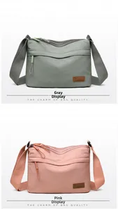 Close-up of lightweight nylon crossbody bag showing multiple zipper pockets and branding