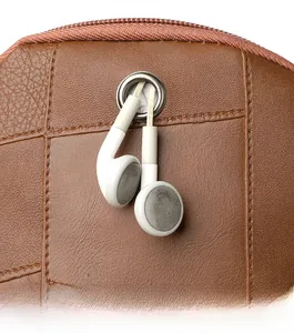 Detail of brown litchi pattern leather bag featuring a functional headphone jack and zipper