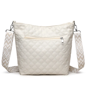Quilted crossbody bag in beige with diamond stitching and adjustable woven strap