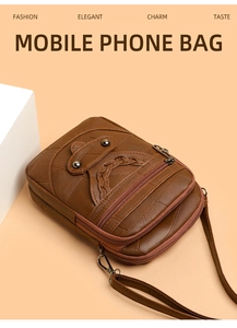 Detail of dark brown leather phone bag showing triple zipper compartments and weave texture
