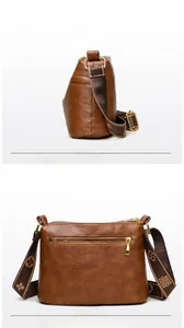 Detail of brown leather crossbody bag featuring patterned wide strap and gold hardware