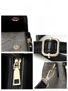 Detailed close-up of golden metal zipper and hardware on a black woven texture bag