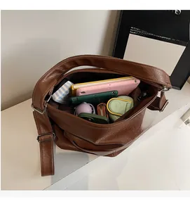 Draufsicht der braunen Ledertasche mit Platz für Tablet, Regenschirm und Smartphone