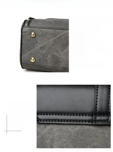 Detail of bottom anti-wear gold studs and fine stitching on the grey leather handbag