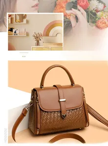 Close-up of dark brown leather crossbody bag featuring woven texture and metal lock