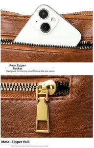 Close-up of brown pebbled leather bag featuring a back zipper pocket with gold-tone hardware