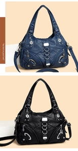 Detail of large shoulder bags in black and blue leather with multiple zipper pockets
