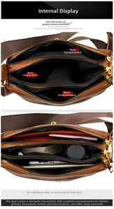 Detail view of large capacity crossbody bag interior with three main zipper compartments