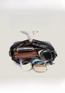 Interior view of black crossbody bag showing three layers of spacious compartments