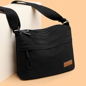 Waterproof multi-layer nylon crossbody bag with adjustable strap and front logo