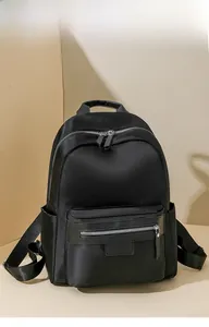Detailed shot of black nylon travel backpack with silver zippers and side pockets
