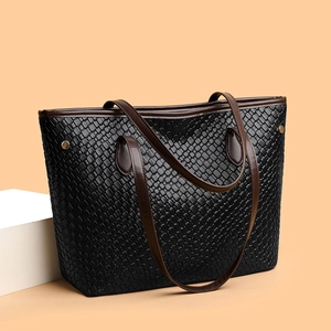 Vintage woven black leather tote bag with brown straps and spacious interior
