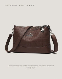 Deep brown crocodile embossed crossbody bag with three zip layers and silver logo hardware