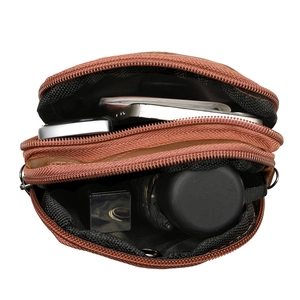 Brown leather crossbody bag with dual zipper compartments showing phone and lipstick storage