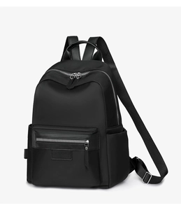 Detailed side view of high-capacity black nylon backpack with silver zippers and leather trim