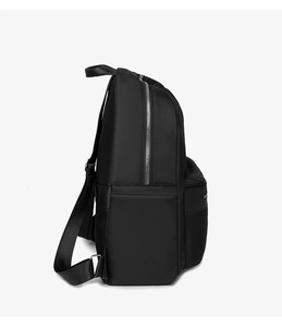 Detail view of durable nylon backpack showing silver metal zippers and side pocket texture