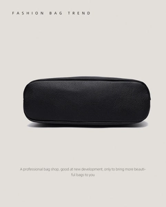 Detail shot of the black lychee pattern leather base with high-quality stitching on the bag