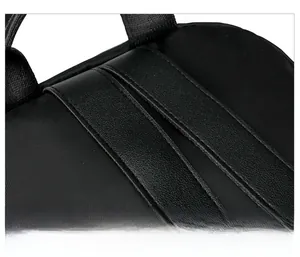 Detail of reinforced stitching and faux leather patchwork on the black nylon backpack strap