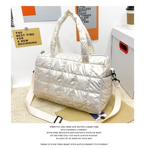 Detail of pearl white quilted space cotton tote bag showing texture and crossbody strap