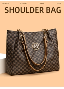 Detailed shot of dark brown tote bag featuring M-pattern print and metallic logo