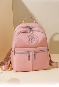 Detail eines rosa Nylon-Rucksacks mit Reißverschlusstaschen und Kleeblatt-Logo