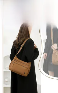 Close-up of lightweight nylon shoulder bag with multi-pocket design and adjustable strap