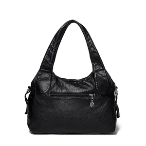 Black pebbled leather tote bag with silver floral zipper pull on white background