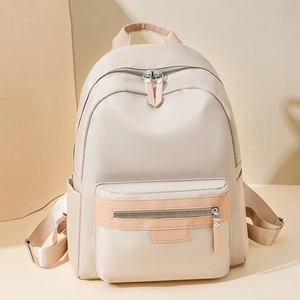 Minimalist beige nylon backpack with large capacity and brown leather zip pull accents