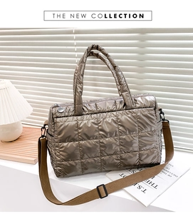 Close-up of quilted metallic bronze puffer tote bag with adjustable shoulder strap detail