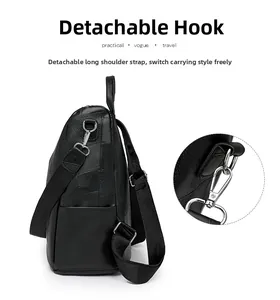 Detail of detachable shoulder strap and silver metal hook on black leather backpack