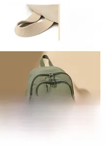 Detail of green nylon backpack showing durable straps and multi-layer zipper compartments