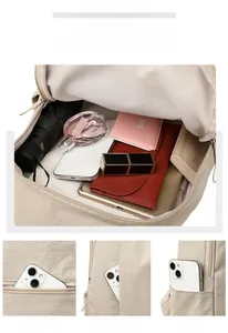 Detailed view of spacious beige oxford backpack interior with multiple storage pockets
