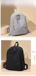 Detail view of lightweight nylon backpacks in grey and black with multi-pocket design