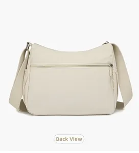 Back view of cream nylon crossbody bag featuring rear zipper pocket and side pouches