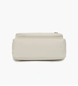 Detailed bottom view of large capacity beige nylon shoulder bag with neat stitching