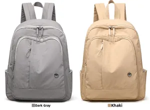 Detail view of lightweight Oxford fabric backpacks in dark grey and khaki colors
