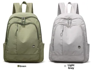 Side-by-side view of green and light grey nylon backpacks with dual zipper compartments