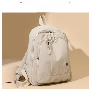 Detail of minimalist cream oxford backpack featuring large capacity and durable zippers