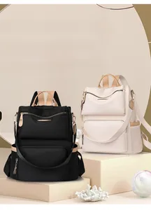 Close-up of stylish large capacity anti-theft travel backpacks in black and ivory colors