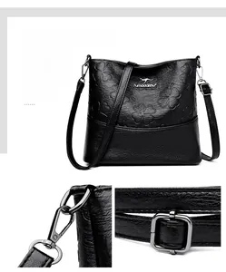 Détail du sac seau en cuir noir avec trèfles embossés et boucles en métal argenté