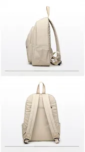Side and back view of a beige lightweight oxford cloth backpack with multiple storage pockets