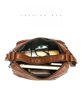 Top view of brown multi-layer crossbody bag showing spacious interior with daily items