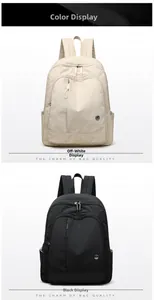 Detail view of Oxford fabric backpacks in cream and black colors with front zipper pockets