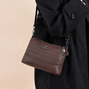 Women's dark brown multi-layer crossbody bag with textured leather and metal logo