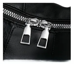Detail of high-quality black leather texture with durable silver metal double zippers